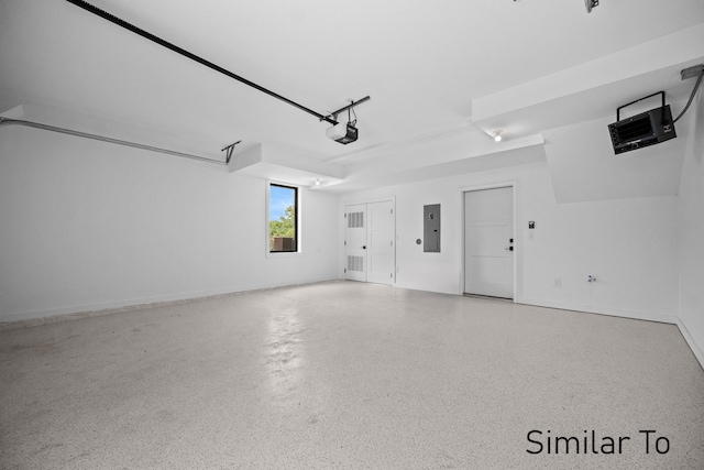 garage with a garage door opener and electric panel