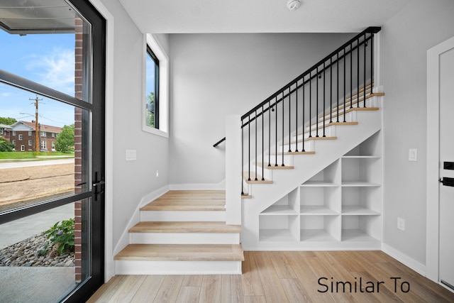 stairs with hardwood / wood-style floors