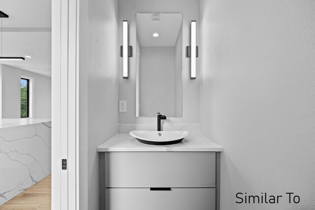 bathroom featuring vanity and hardwood / wood-style flooring