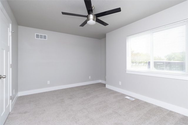 unfurnished room featuring light carpet and ceiling fan