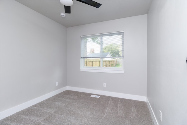 spare room with ceiling fan and carpet