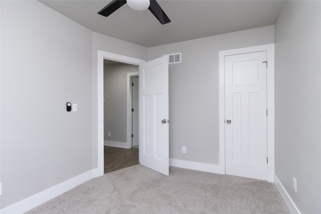 unfurnished bedroom with ceiling fan and light carpet