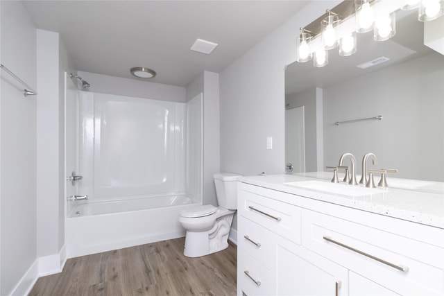 full bathroom with vanity, toilet, hardwood / wood-style flooring, and  shower combination