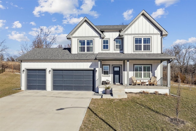 view of front of property with a porch, a garage, and a front yard