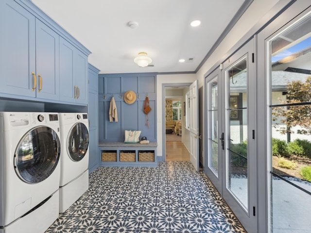 laundry room featuring a healthy amount of sunlight, cabinets, independent washer and dryer, and french doors