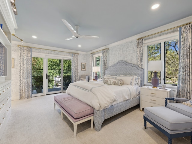 bedroom with multiple windows, ceiling fan, light colored carpet, and access to exterior