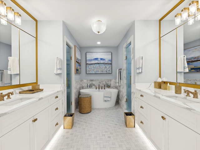 bathroom featuring a tub, vanity, and tile walls