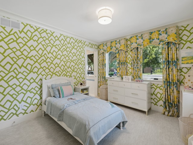 bedroom with crown molding and light carpet