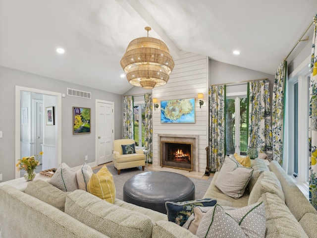 carpeted living room with a large fireplace and vaulted ceiling