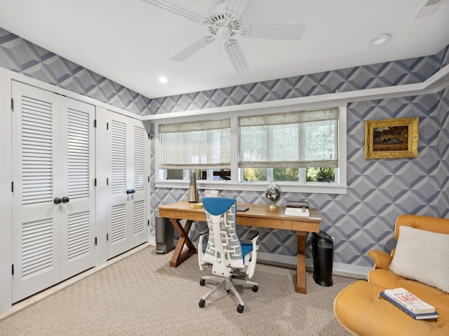 carpeted home office featuring ceiling fan