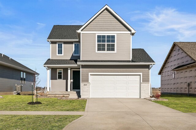 view of front of home featuring a garage and a front yard