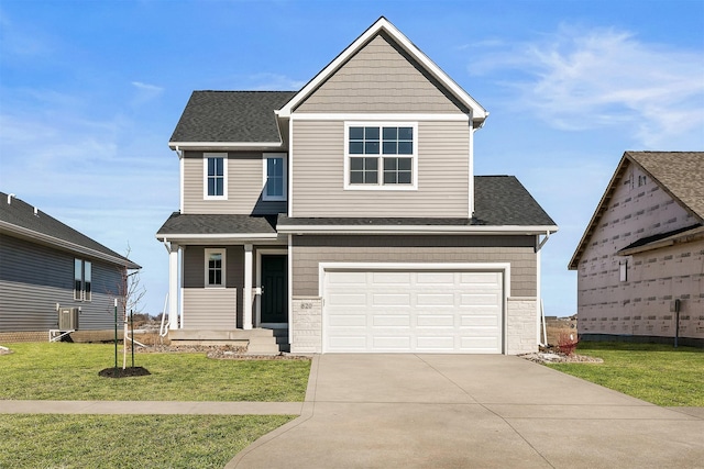 view of front of property with a garage and a front lawn