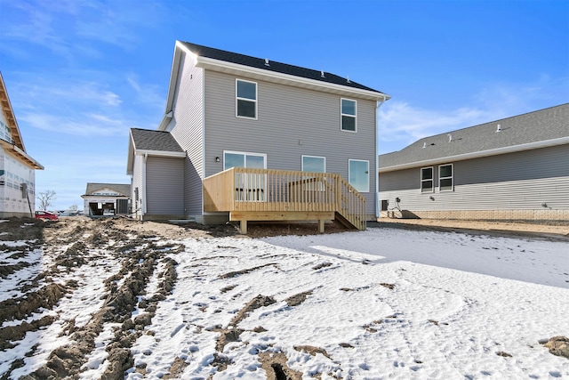 snow covered property featuring a deck