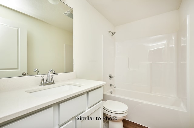 full bathroom with hardwood / wood-style floors, vanity, toilet, and shower / bath combination