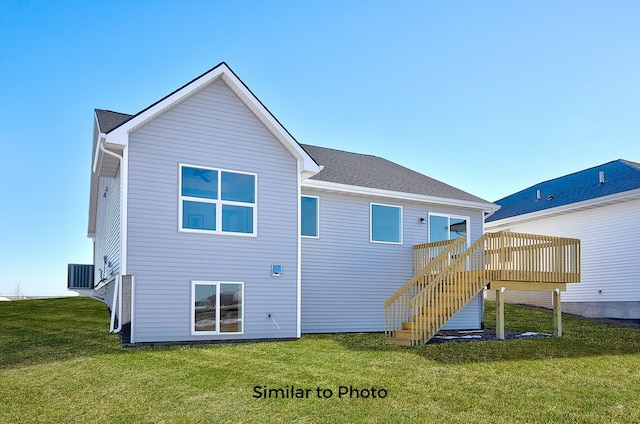 rear view of property with central air condition unit, a yard, and a wooden deck