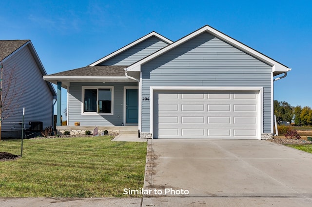 view of front of property with a garage and a front lawn