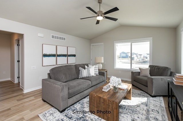 living room featuring light hardwood / wood-style floors, ceiling fan, and lofted ceiling