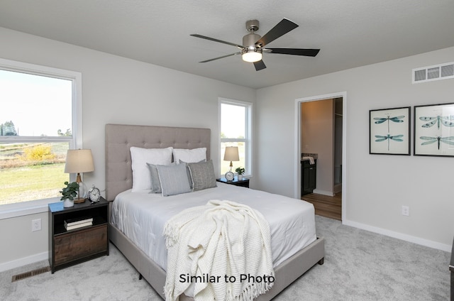 bedroom with light carpet and ceiling fan