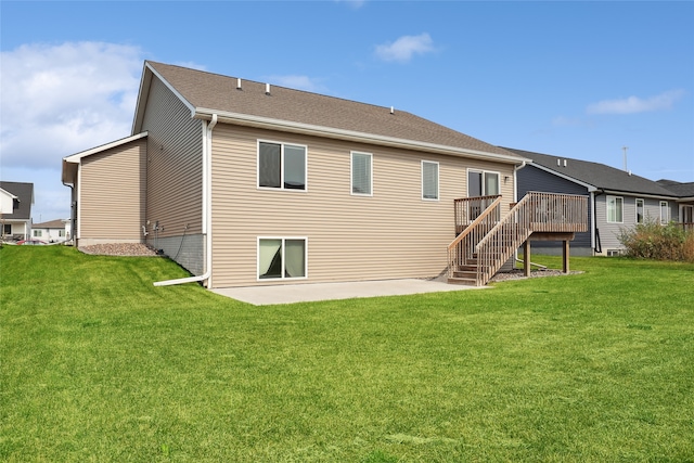 back of property featuring a yard and a patio