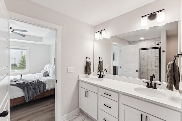 bathroom featuring ceiling fan, hardwood / wood-style flooring, vanity, and walk in shower