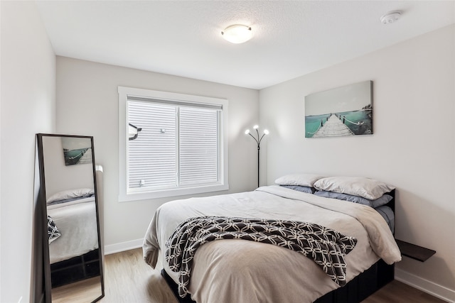 bedroom with hardwood / wood-style floors