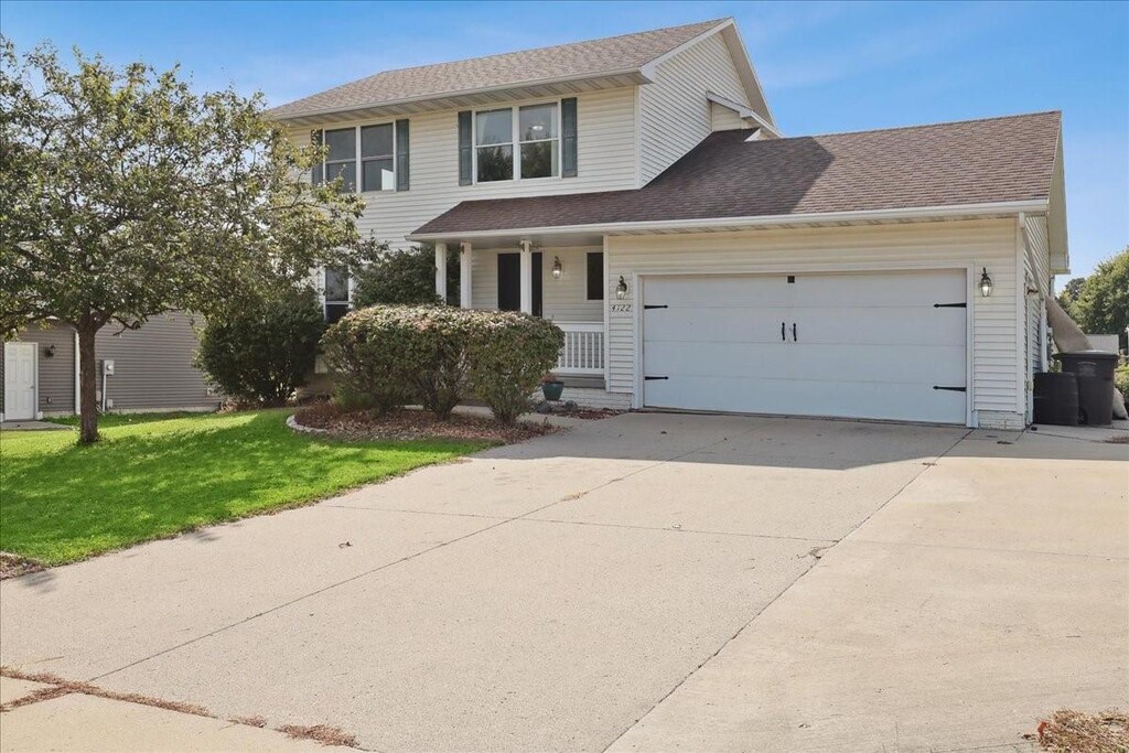 view of front facade with a garage and a front lawn