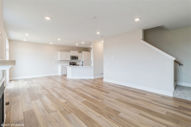 unfurnished living room featuring light hardwood / wood-style floors