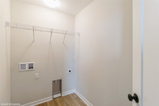 washroom featuring hookup for an electric dryer, wood-type flooring, a textured ceiling, and washer hookup