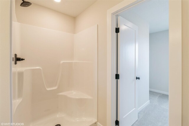 1109 Mulberry Dr NW, Bondurant, IA 50035 - full bathroom with baseboards and a shower