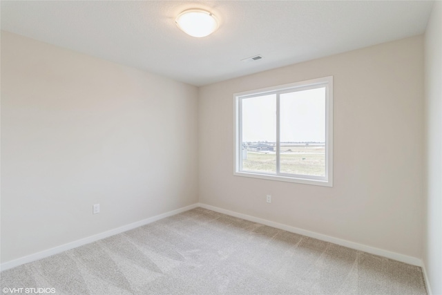 1109 Mulberry Dr NW, Bondurant, IA 50035 - spare room featuring light carpet, visible vents, and baseboards