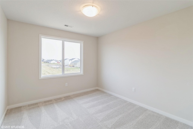 1109 Mulberry Dr NW, Bondurant, IA 50035 - carpeted spare room featuring baseboards and visible vents