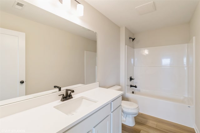 full bathroom featuring vanity, toilet, wood-type flooring, and bathing tub / shower combination