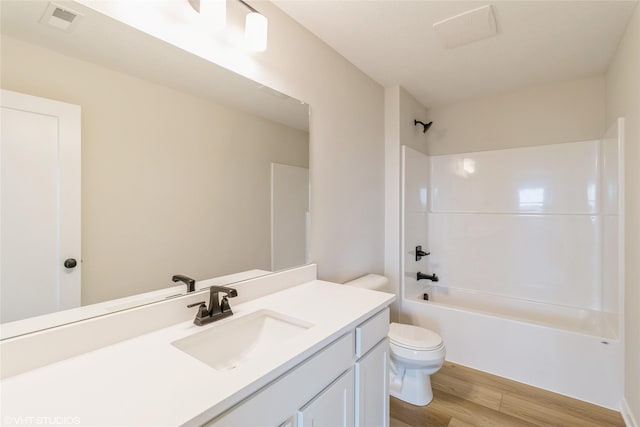 1109 Mulberry Dr NW, Bondurant, IA 50035 - bathroom featuring toilet, visible vents, shower / bath combination, wood finished floors, and vanity