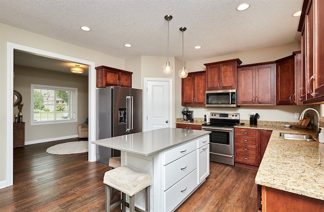 kitchen with a textured ceiling, dark wood-type flooring, stainless steel appliances, sink, and white cabinetry