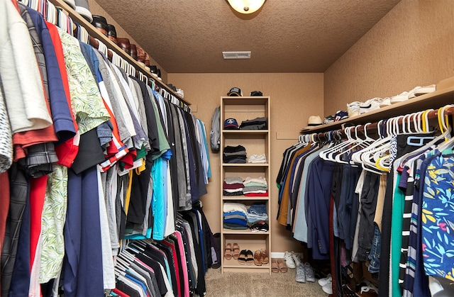 walk in closet featuring carpet