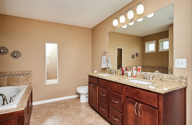 bathroom with toilet, tile patterned floors, vanity, a textured ceiling, and tiled bath