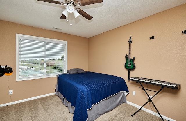 bedroom featuring a textured ceiling, ceiling fan, and carpet flooring