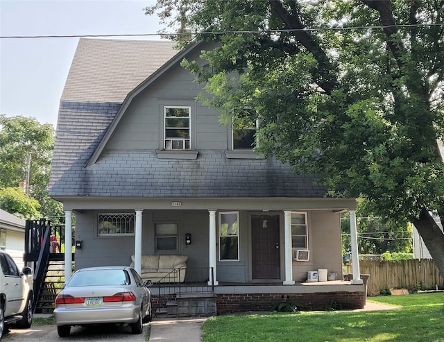 view of front of property with cooling unit and a porch