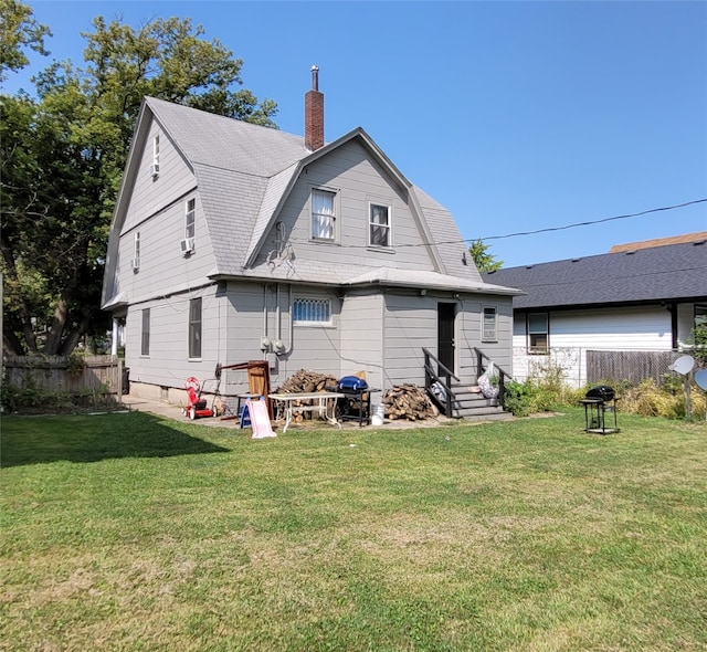 back of property featuring a lawn