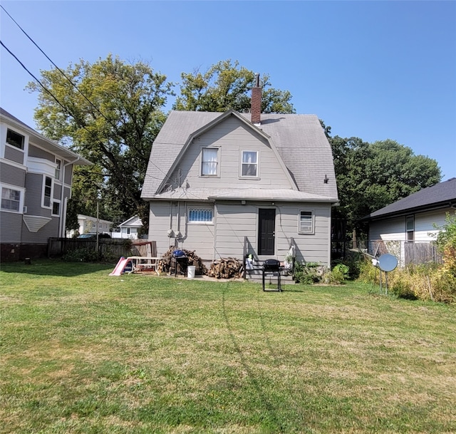 rear view of house with a yard