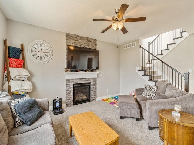 1401 S 10th St, Adel, IA 50003 - carpeted living room featuring stairs, a ceiling fan, a fireplace, and baseboards