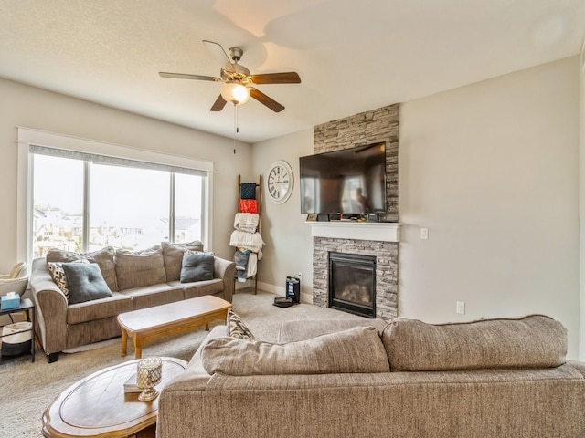 1401 S 10th St, Adel, IA 50003 - carpeted living room featuring ceiling fan, a stone fireplace, and baseboards