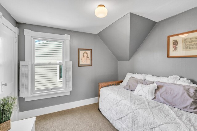 carpeted bedroom with vaulted ceiling