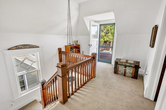 stairs featuring lofted ceiling and carpet flooring