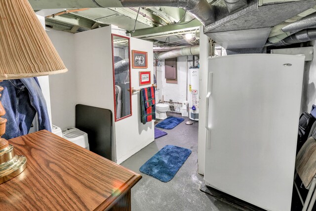 basement featuring electric panel, white fridge, and water heater