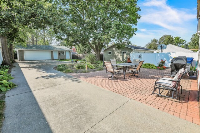 view of patio with an outdoor structure and a garage