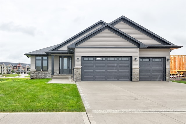 craftsman house with a garage and a front lawn