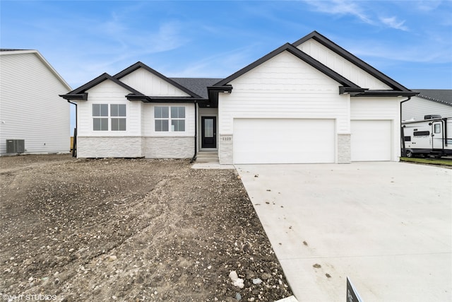 view of front of home with central AC and a garage