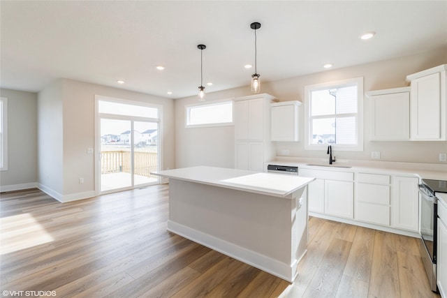 kitchen featuring white cabinets, light hardwood / wood-style flooring, and a kitchen island