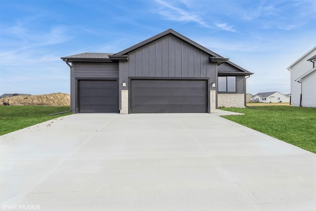 view of front of property with a front yard and a garage